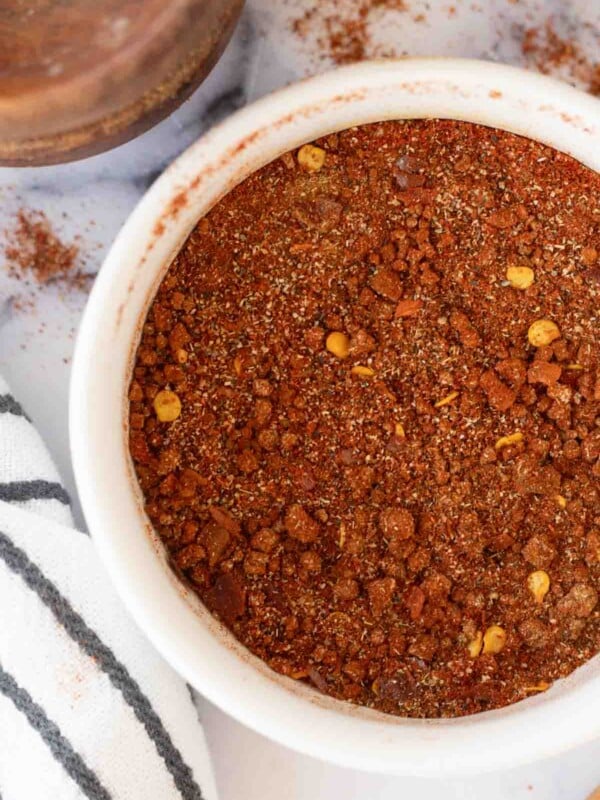 top view of a small white dish of adobo seasoning