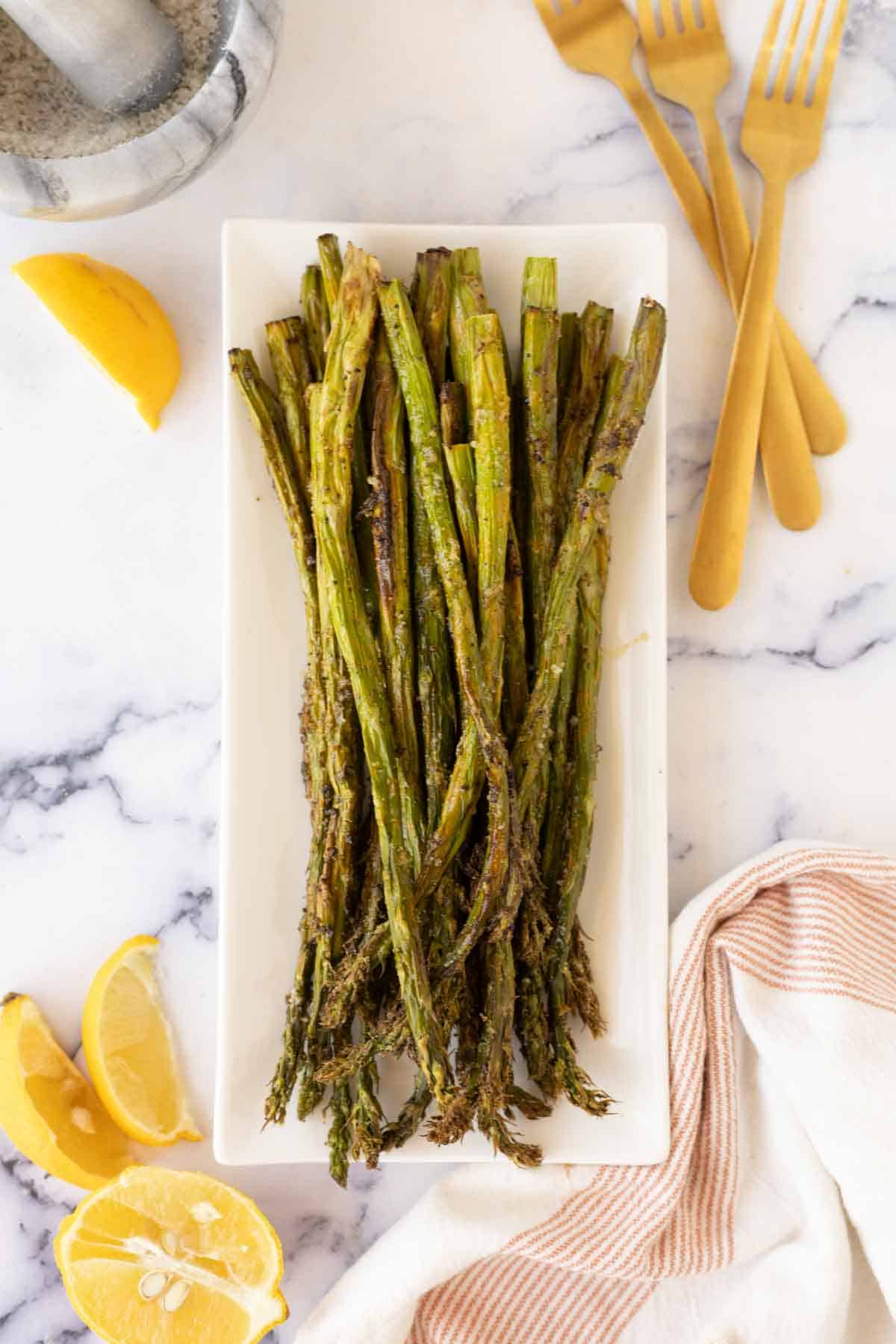top view of air fryer asparagus on a long rectangle plate