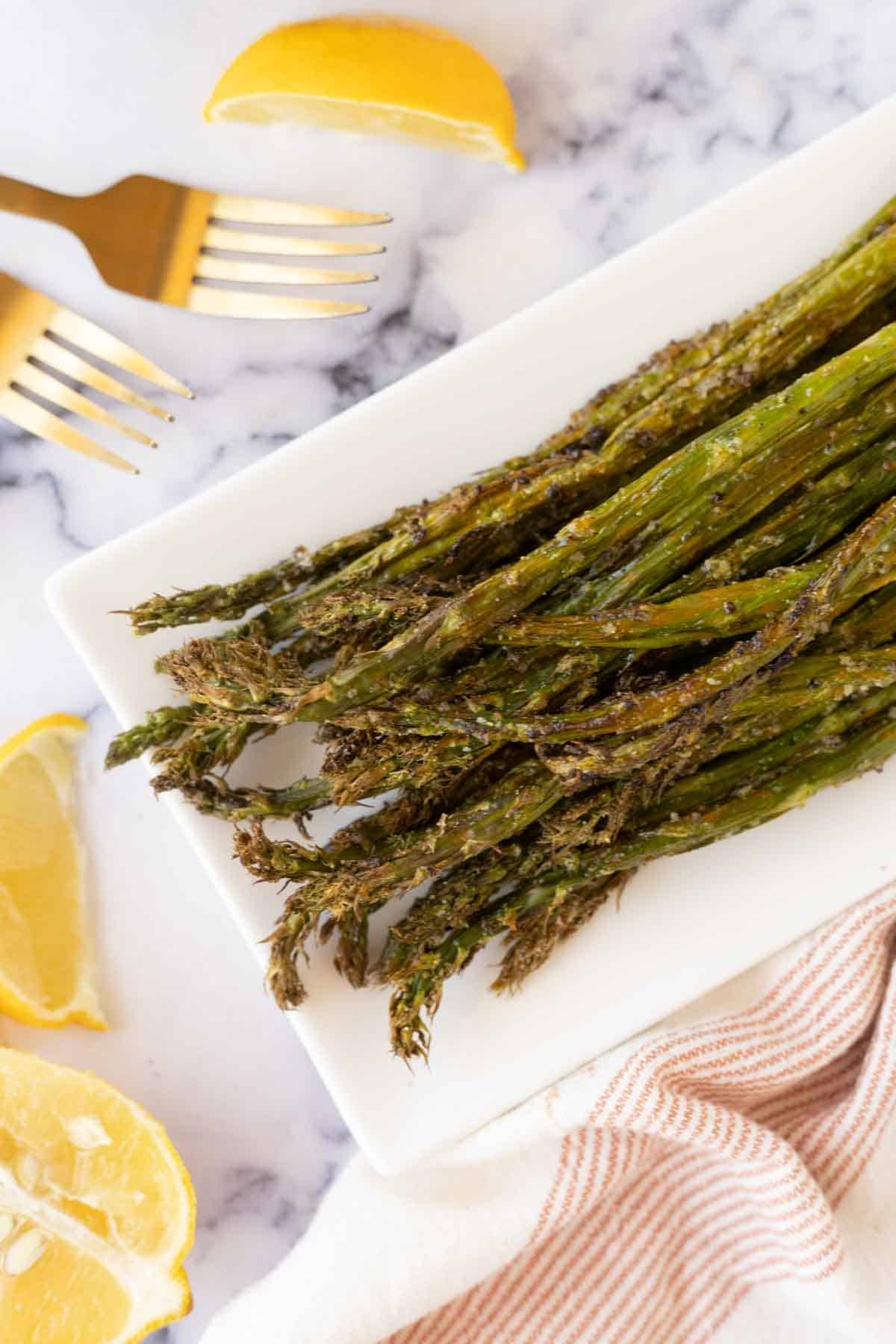top view of the tips of air fryer asparagus on a long rectangle plate