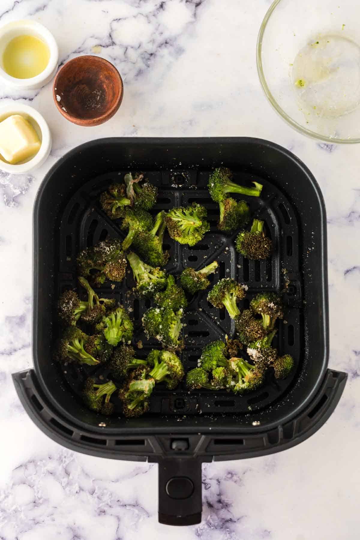 air fryer broccoli seasoned and in the basket