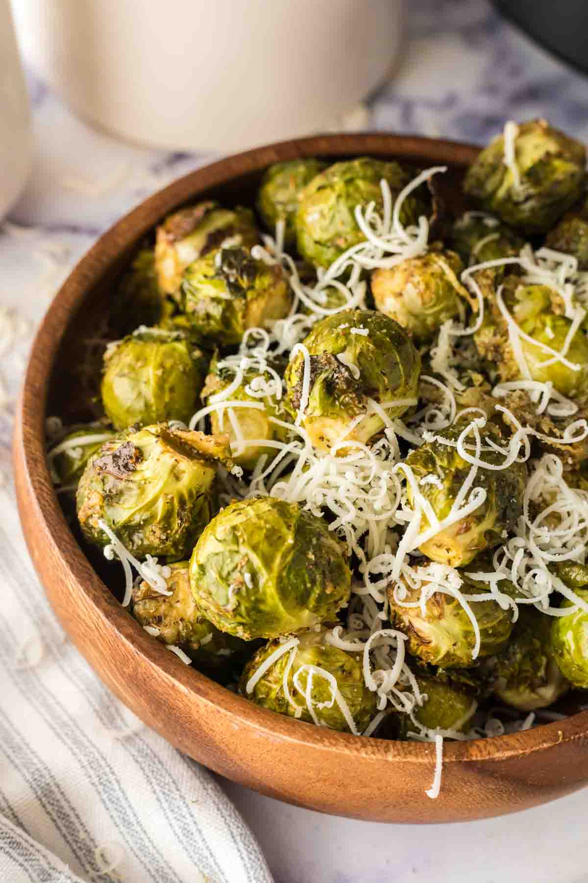 small wooden bowl with air fryer brussel sprouts