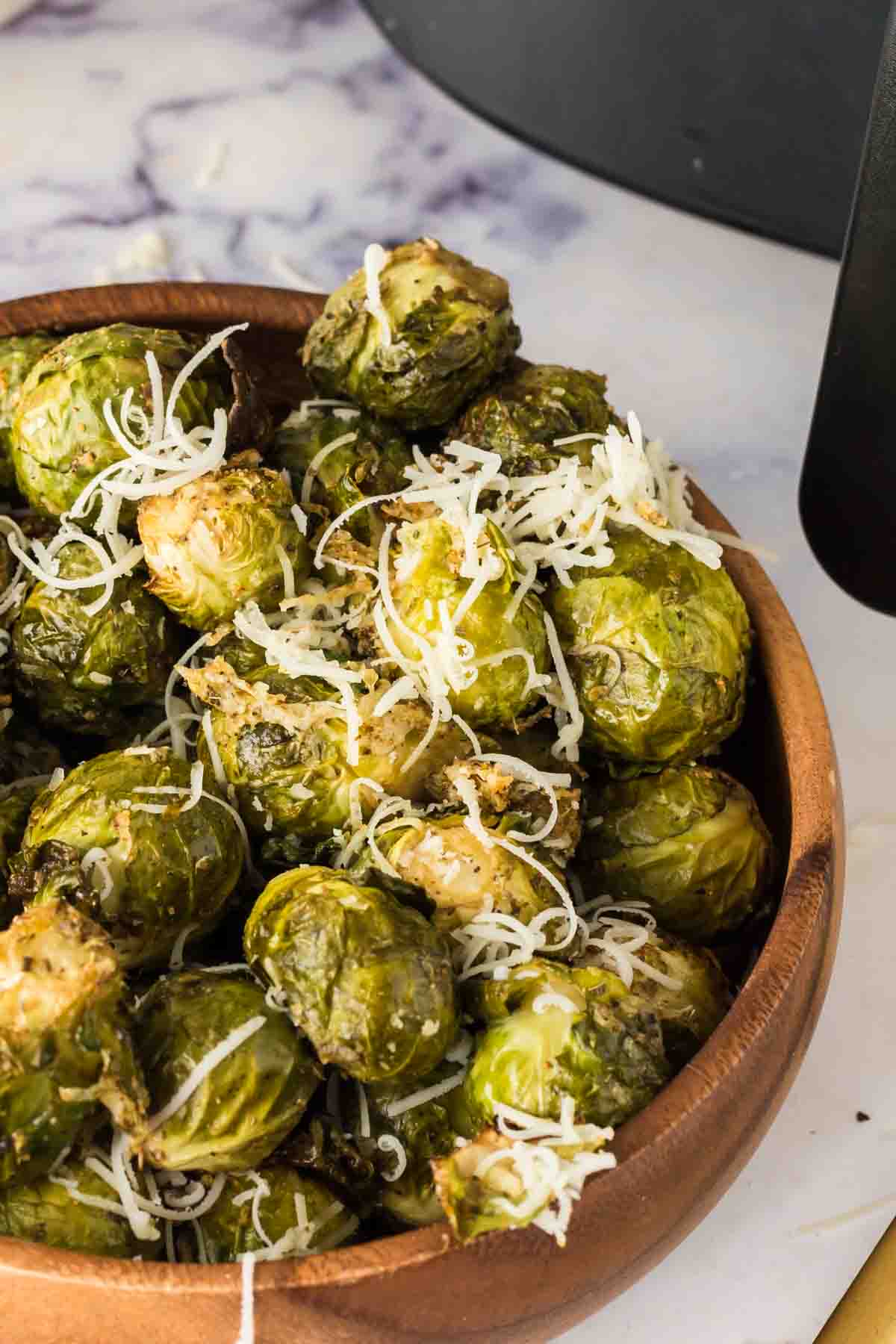 small wooden bowl with air fryer brussel sprouts