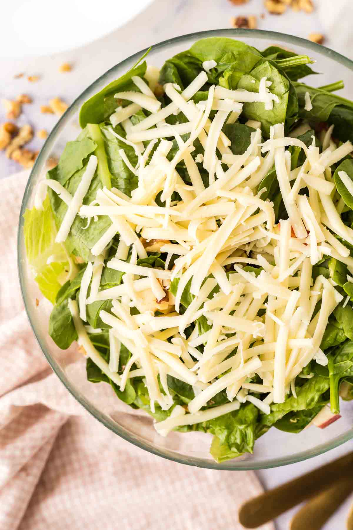 clear bowl with apple salad ingredients