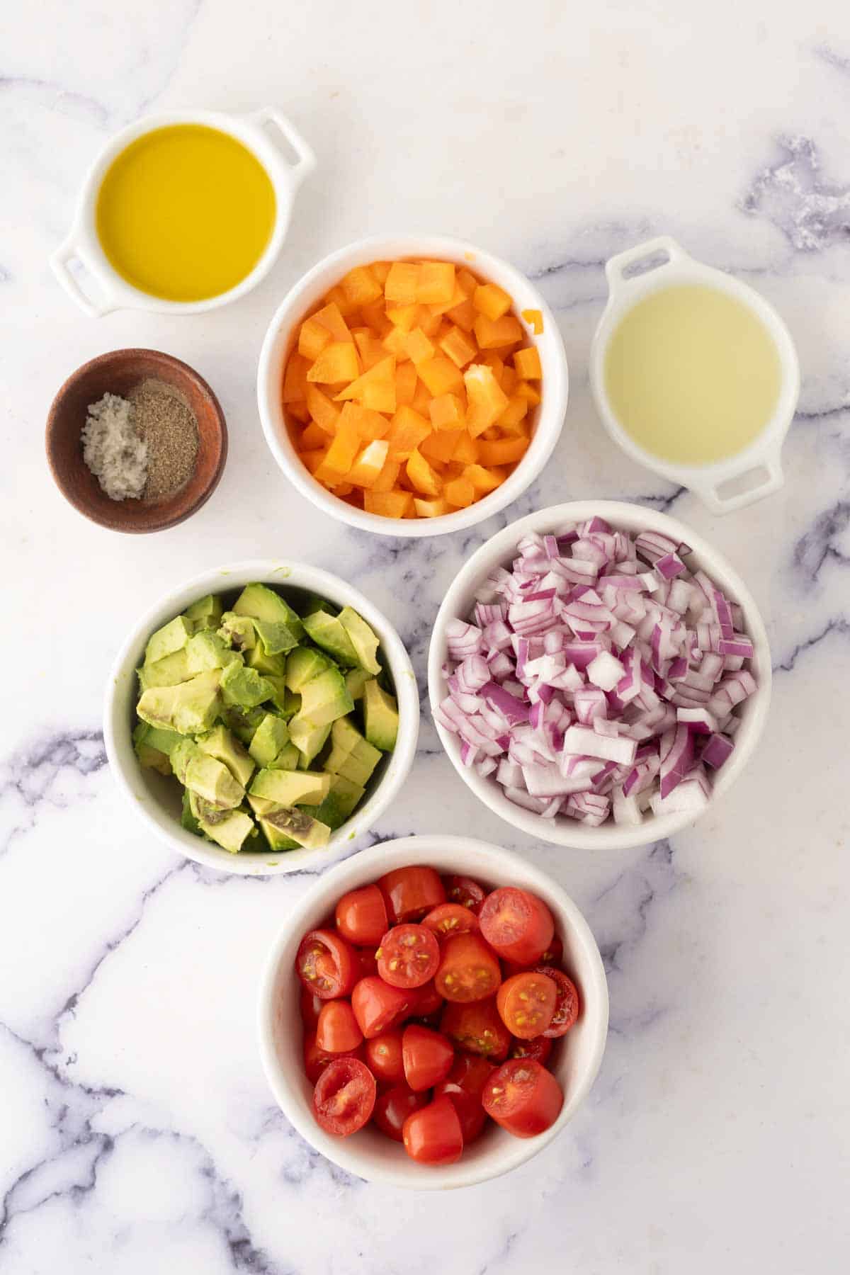 small dishes of portioned ingredients for avocado salad recipe