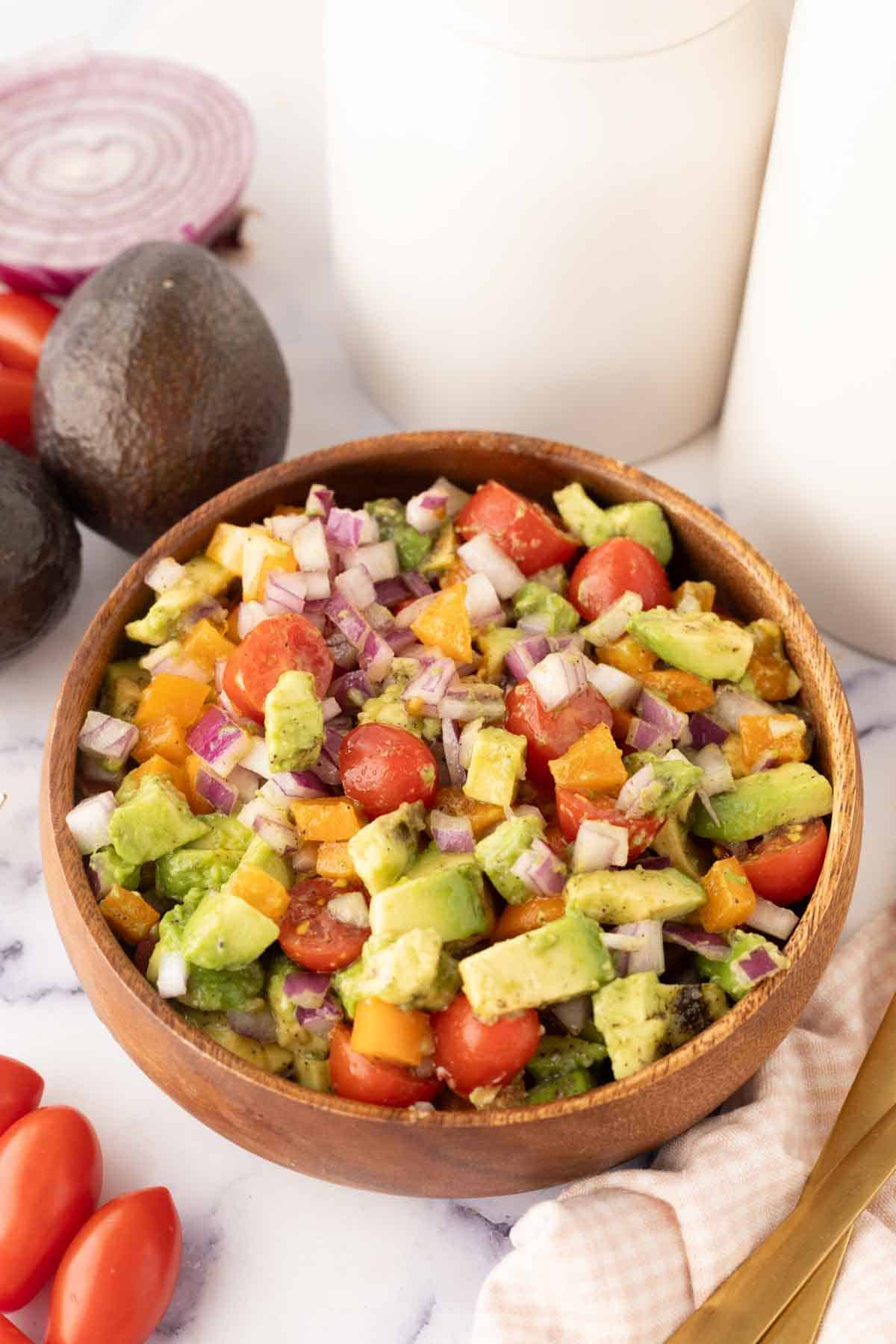 wooden bowl with avocado salad