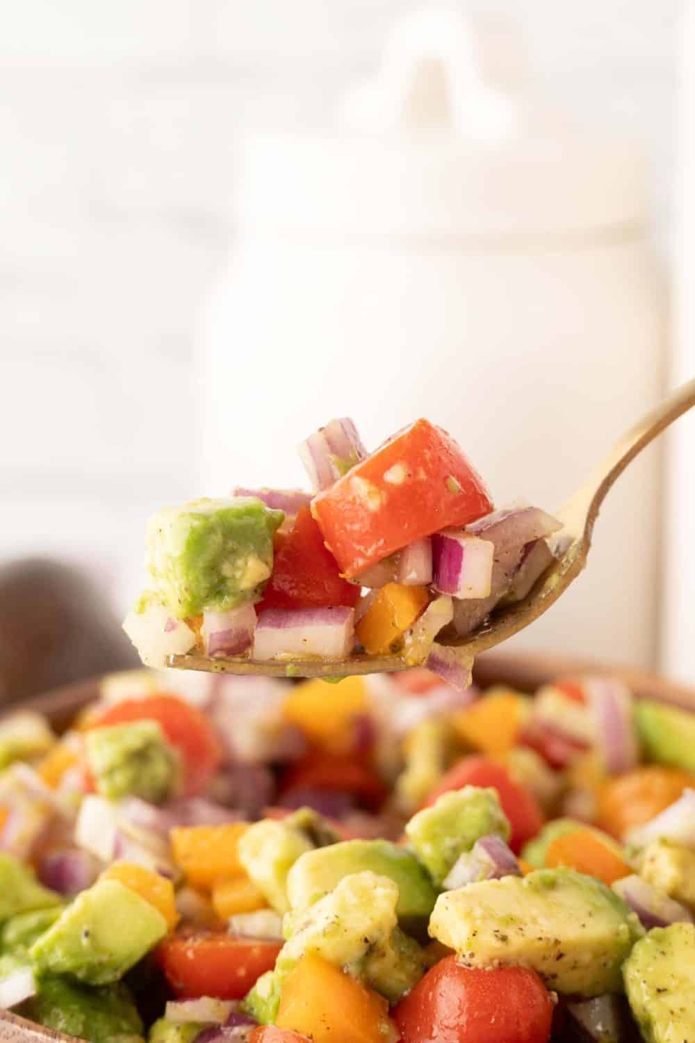 POV forkful of a bite of avocado salad recipe