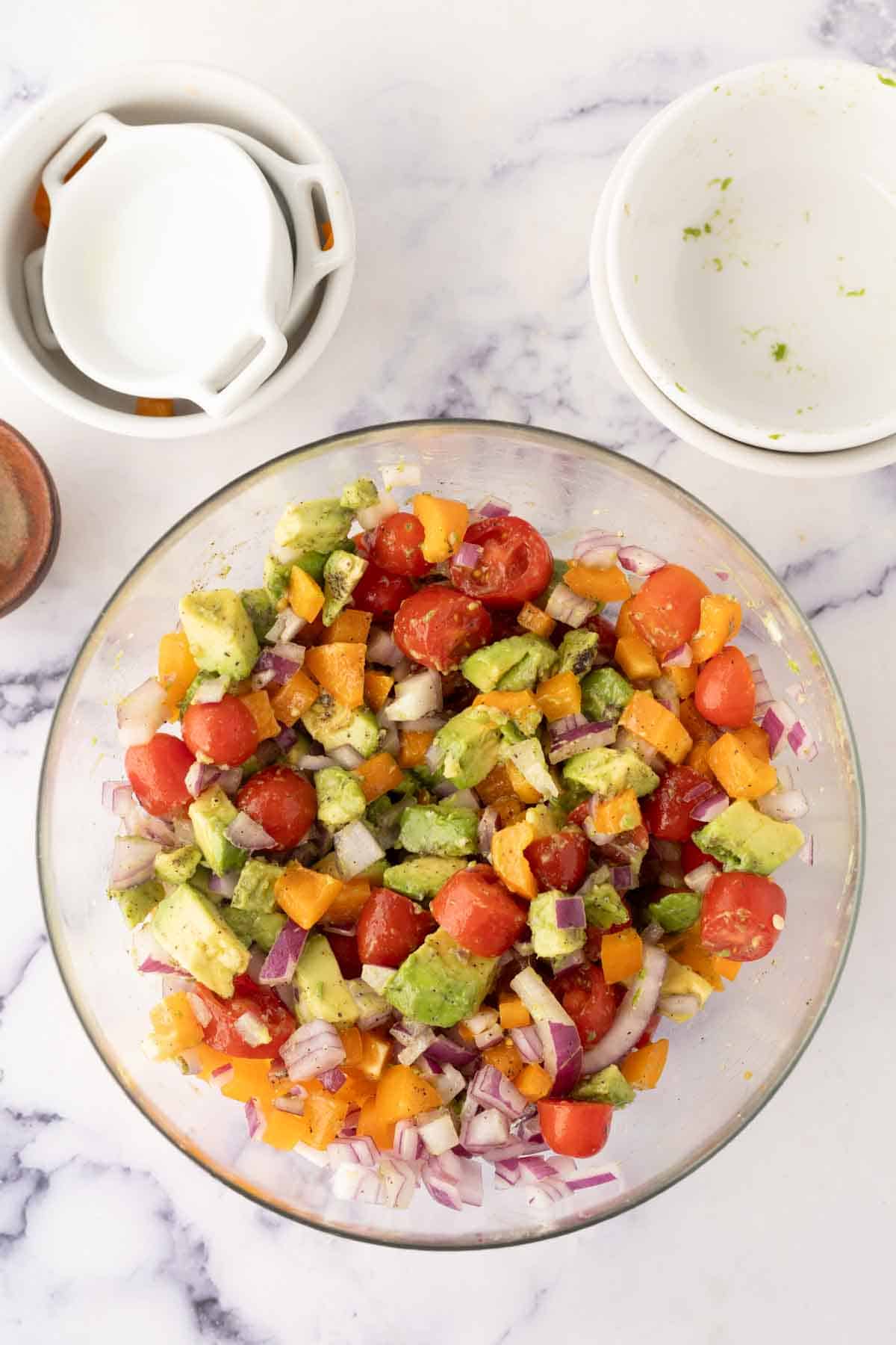 avocado salad recipe in a clear mixing bowl