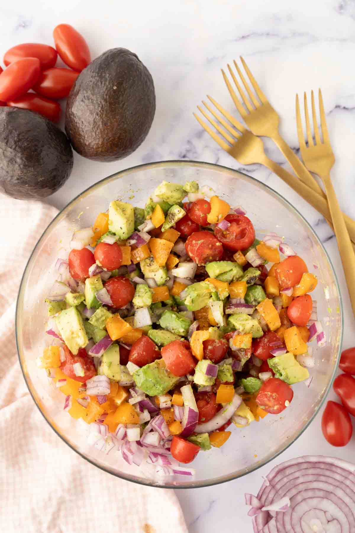 avocado salad recipe in a clear mixing bowl