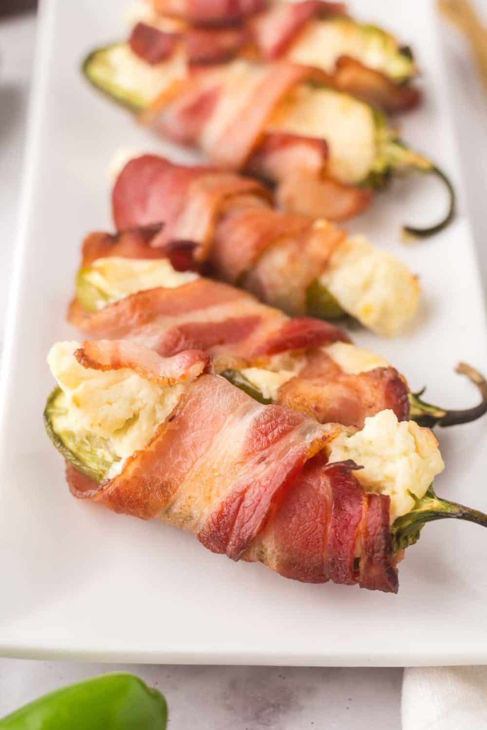 close up of baked bacon wrapped jalapeno poppers