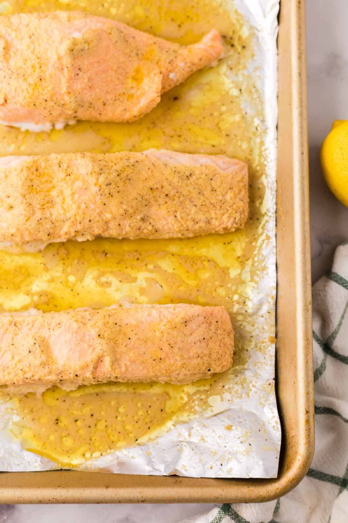 salmon over foil on a baking sheet