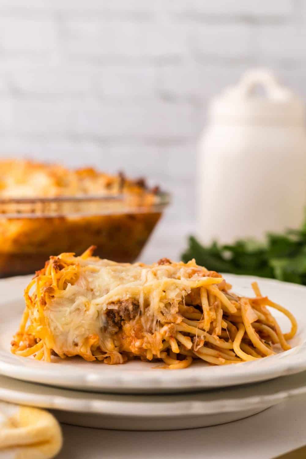 Baked spaghetti served on a white plate.