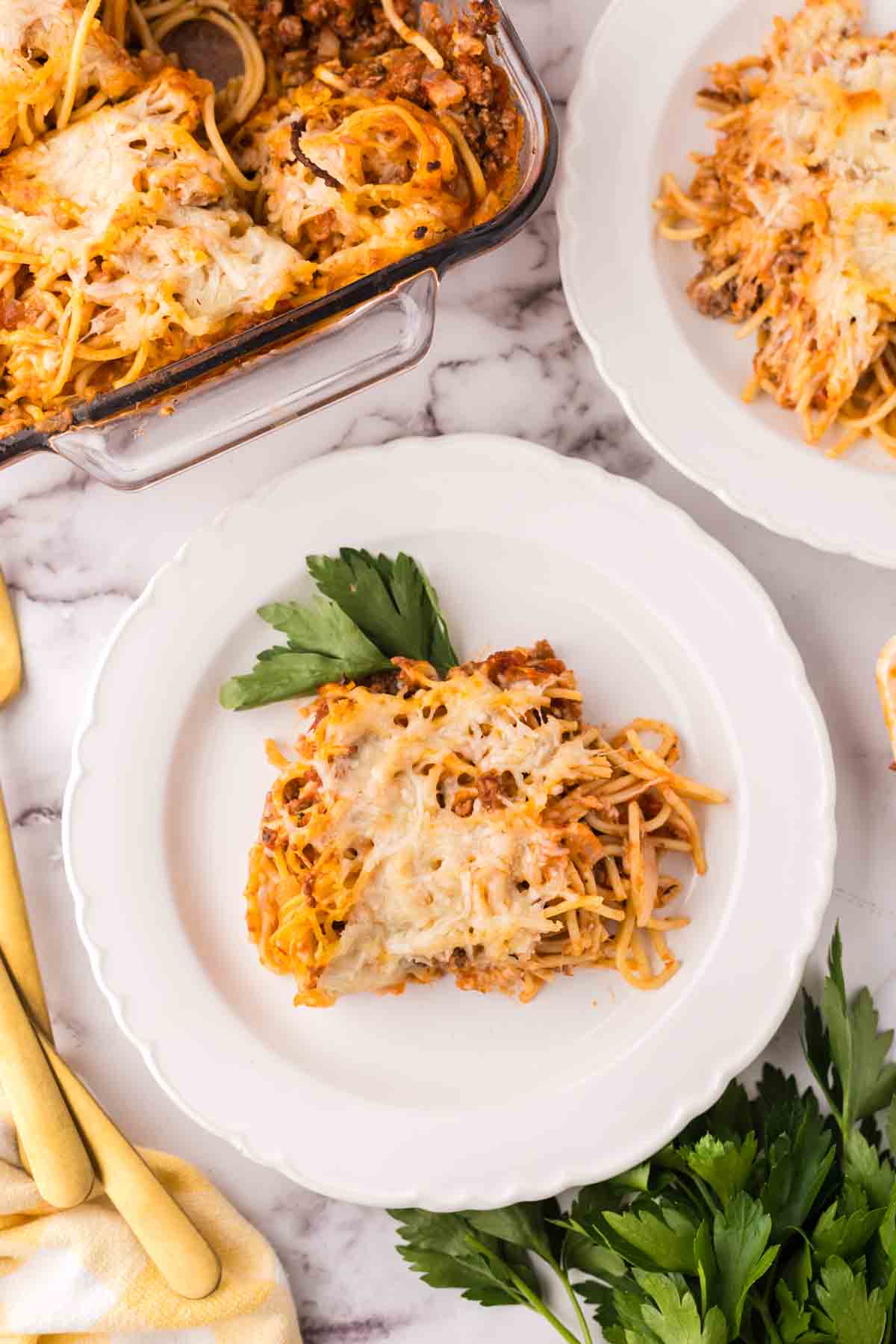 Baked spaghetti served on a white plate.