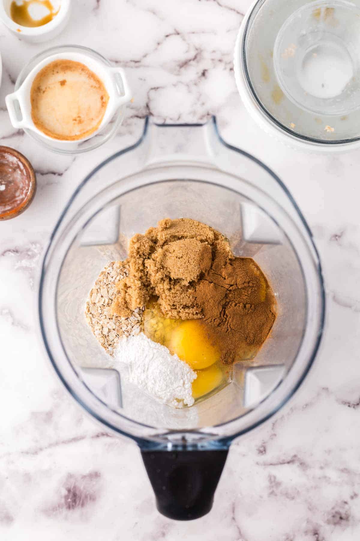 top view of a blender with banana oatmeal pancakes ingredients