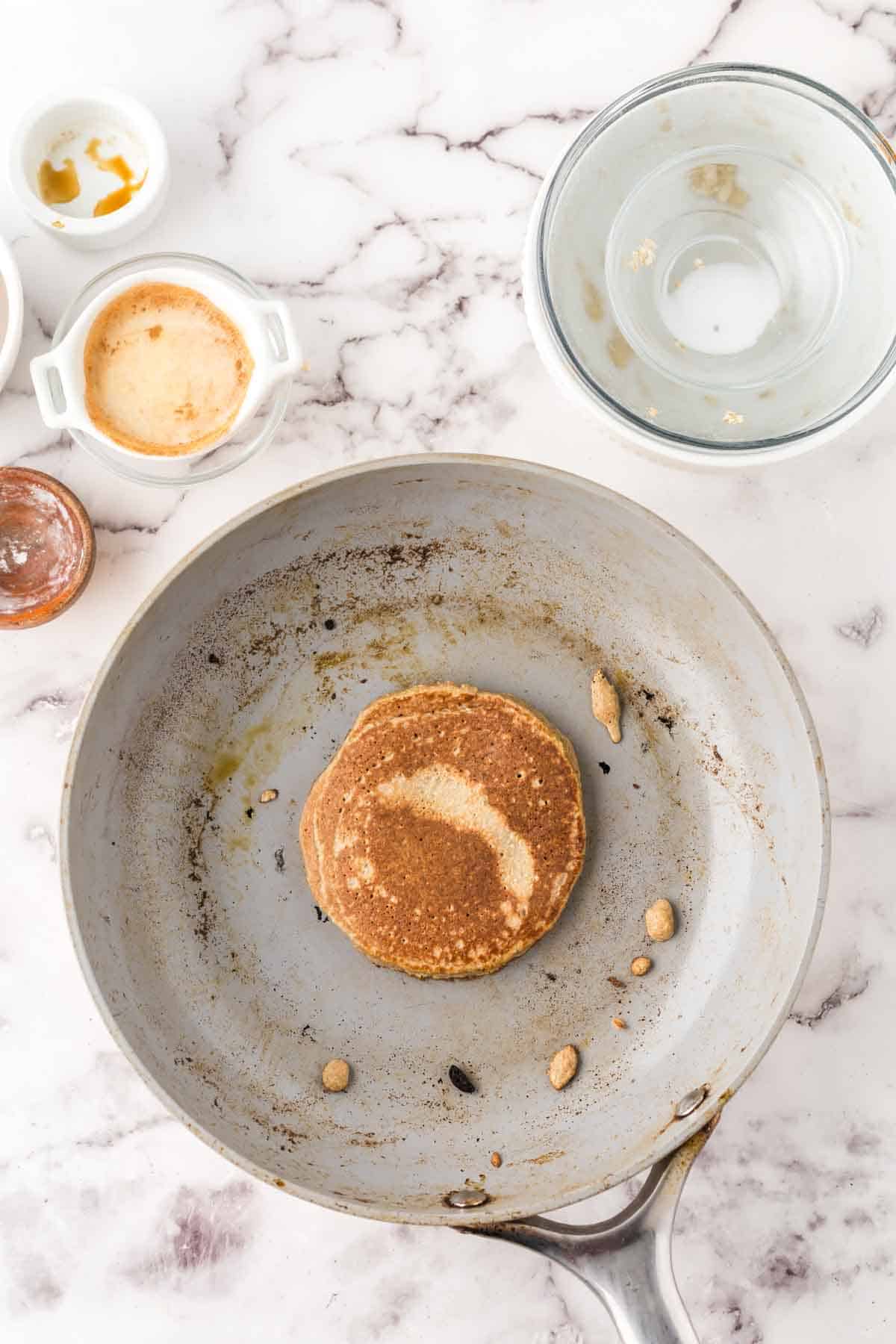 banana oatmeal pancakes in a pan