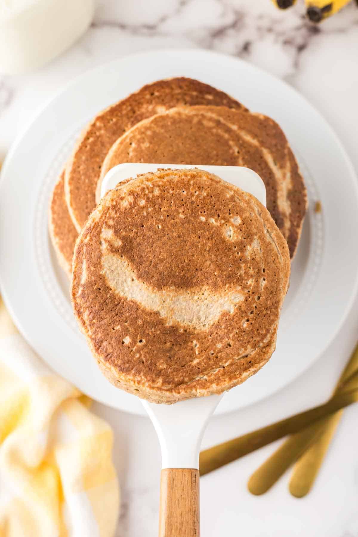 top view with a spatula of a stack of banana oatmeal pancakes