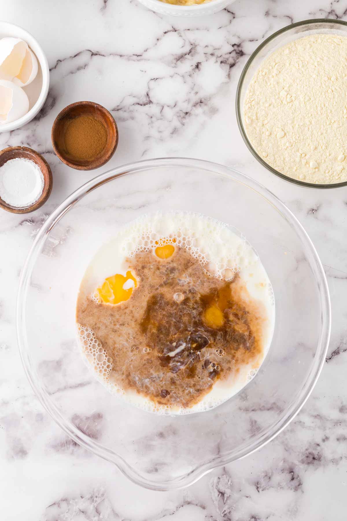 clear mixing bowl with banana pancake ingredients