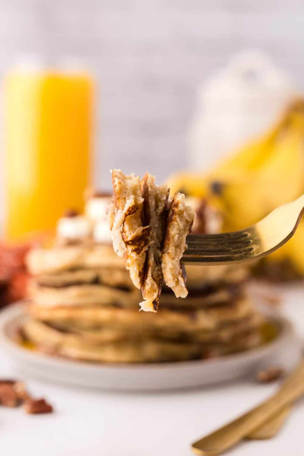 POV forkful of a bite of banana pancakes