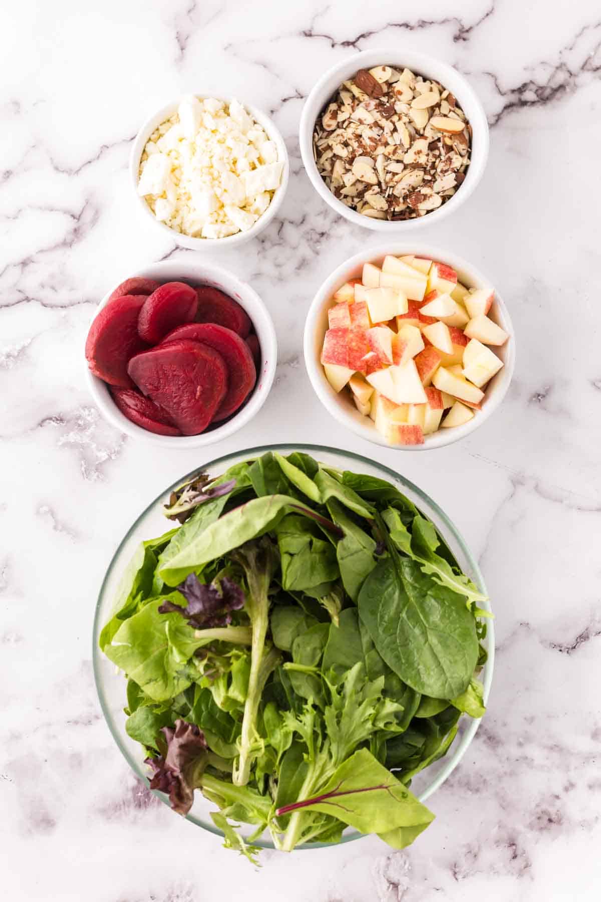 portion bowls with each ingredient to make the beet salad recipe.