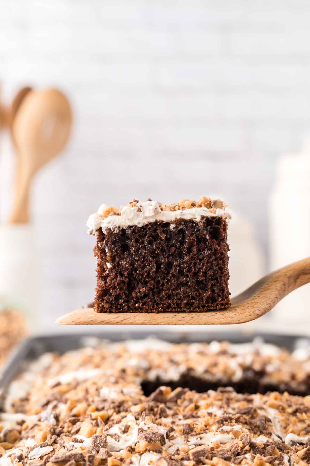 POV side view of a spatula of a square of better than sex cake