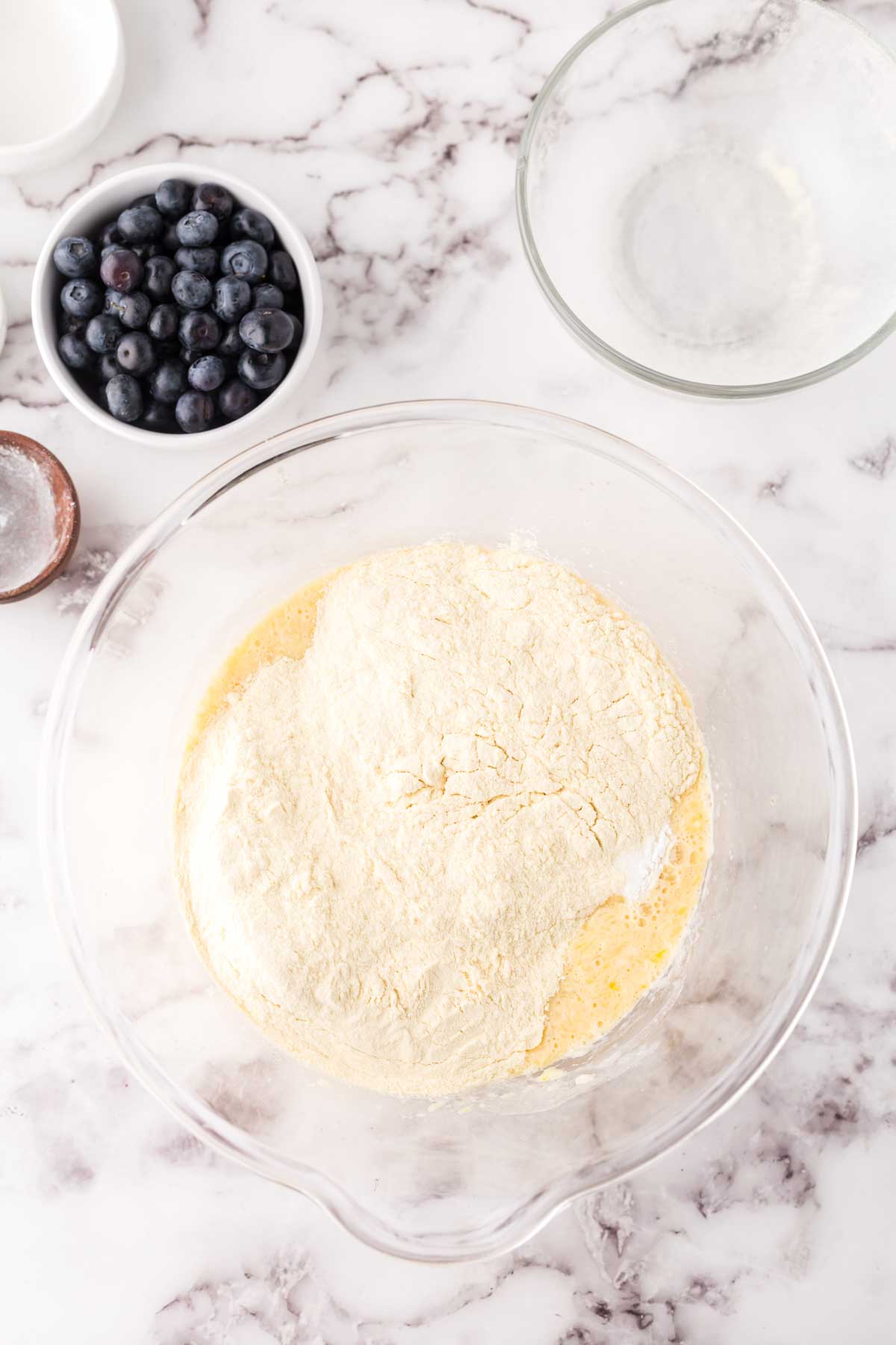 clear mixing bowl for the ingredients in stages for blueberry pancake dough