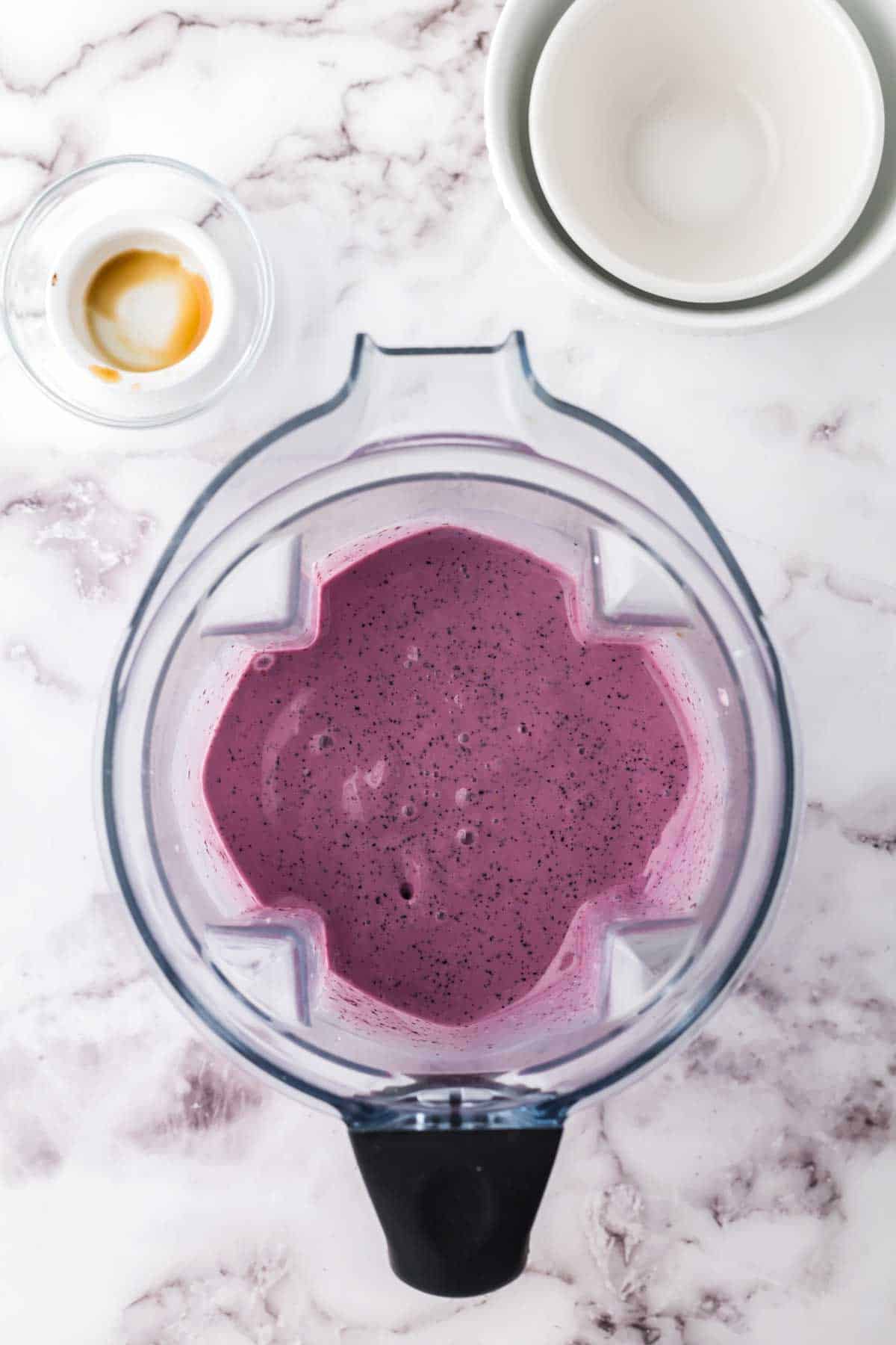 top view into a blender of blueberry smoothie