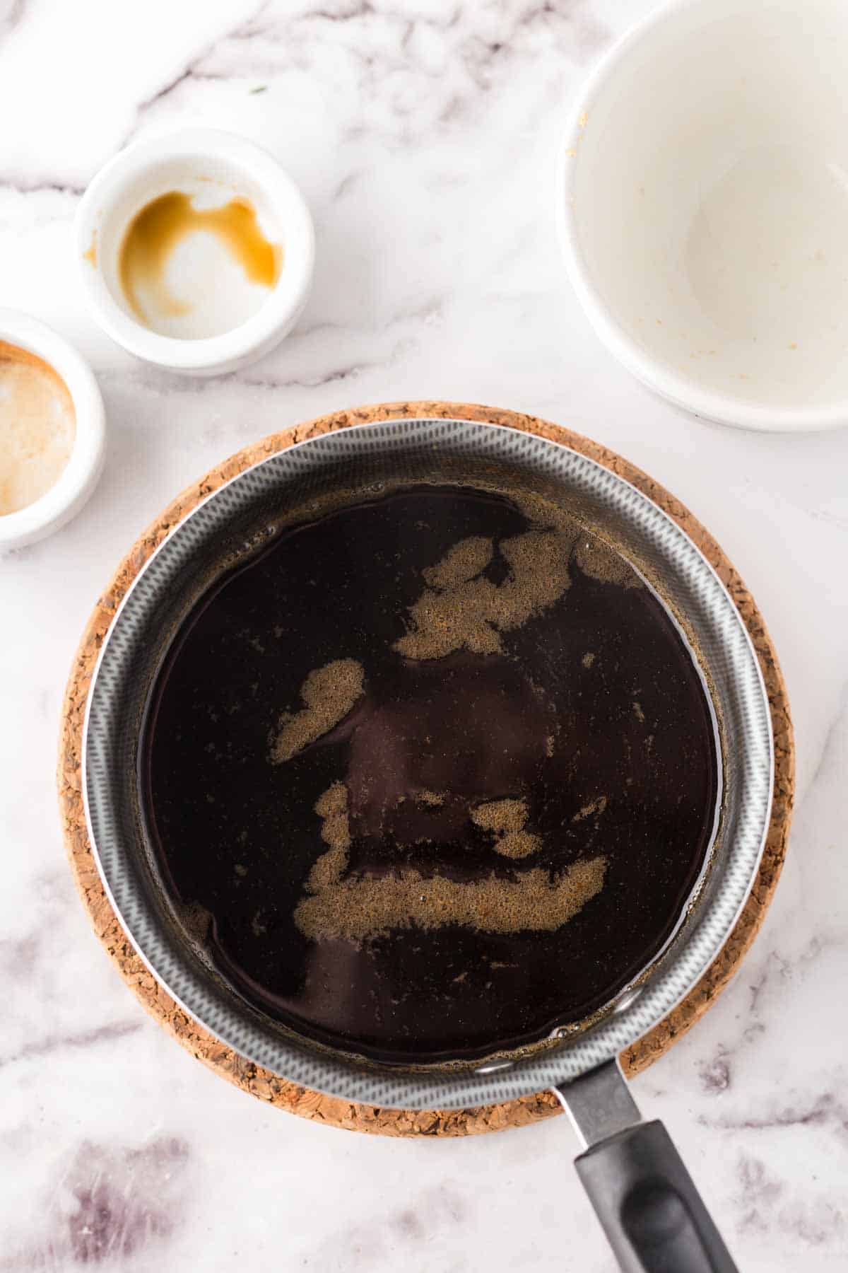 Brown sugar syrup in progress in a sauce pan.