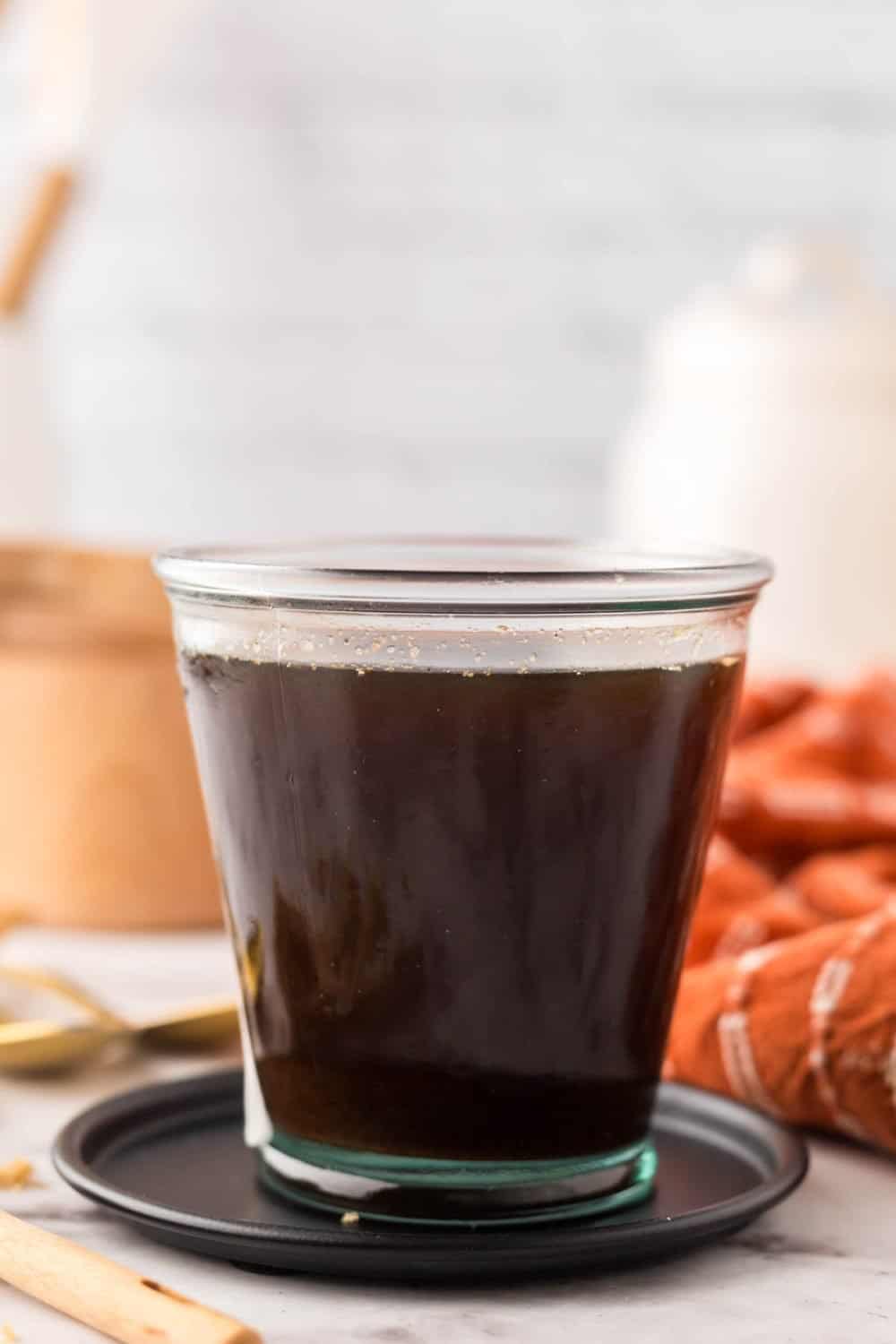 Brown sugar syrup in a small glass jar.