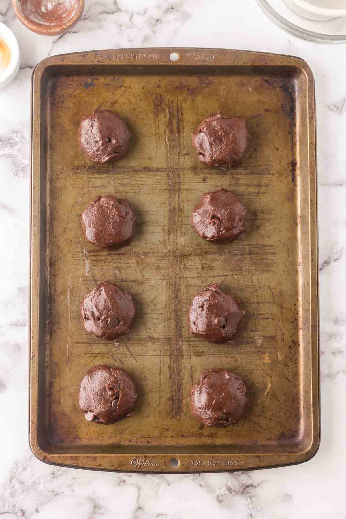 baking dish with raw brownie cookie batter balls