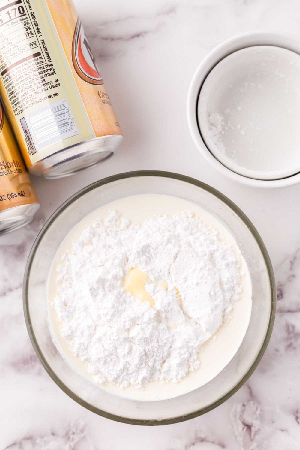 Mixing ingredients in a glass bowl for butterbeer.