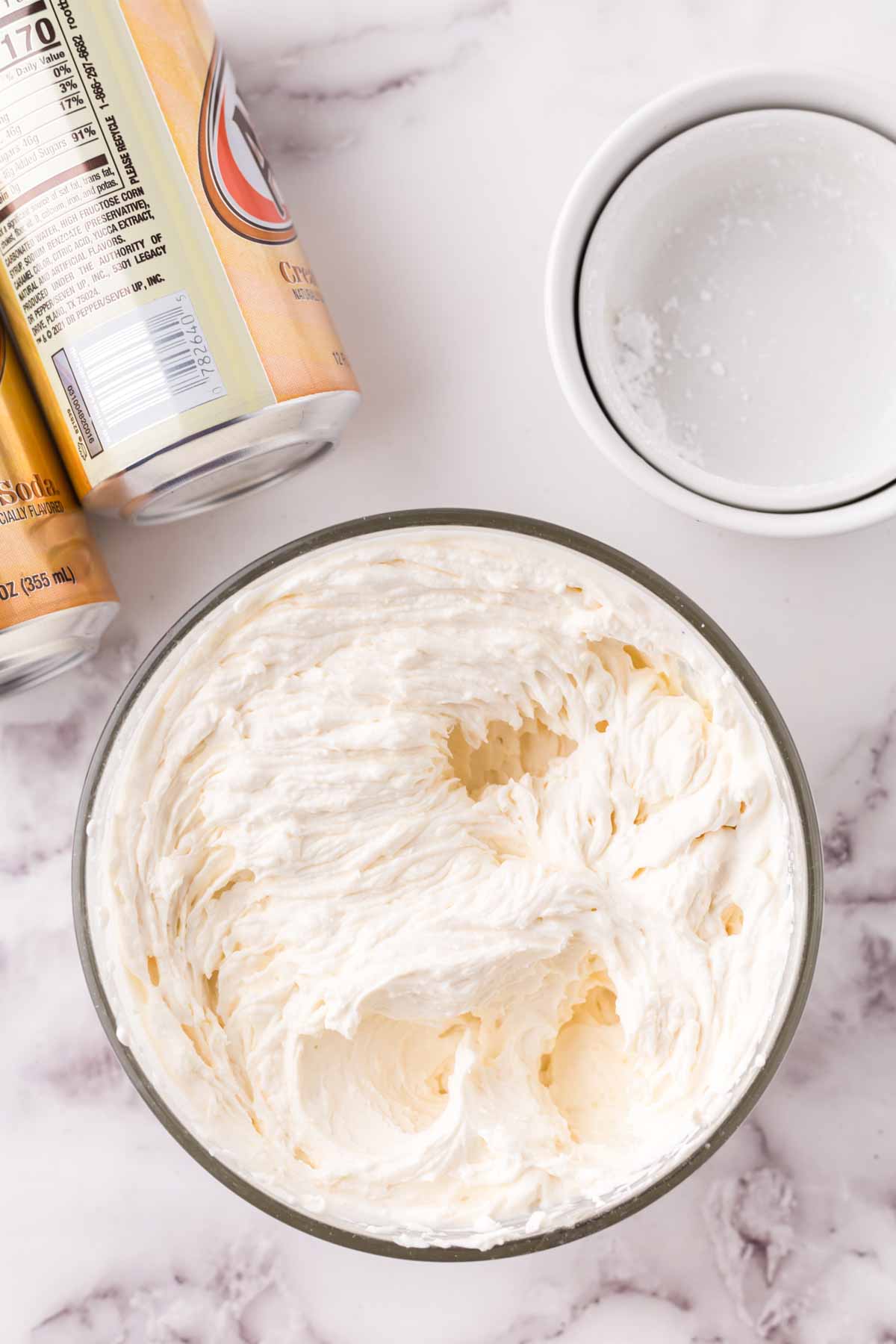 Combining ingredients in a glass bowl for butterbeer.