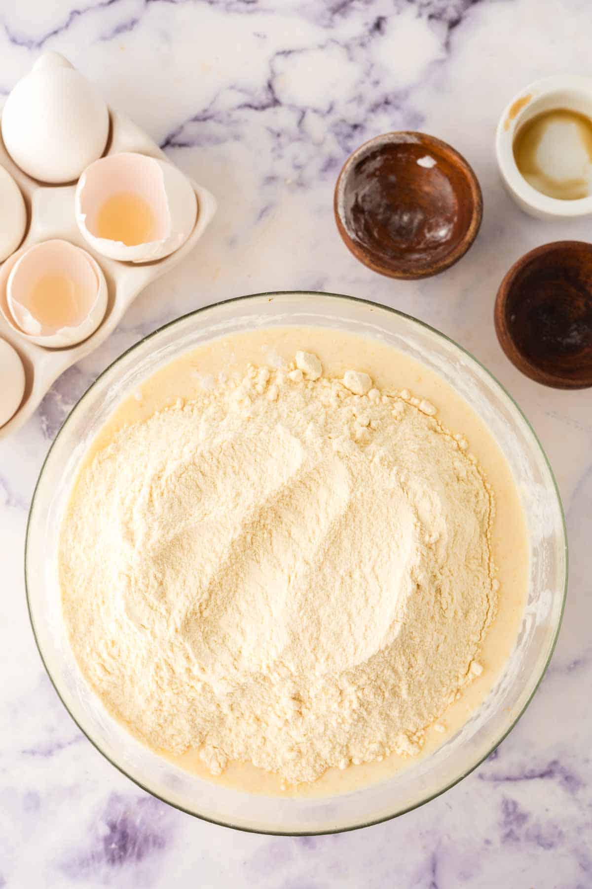 clear mixing bowl with ingredients to make buttermilk waffle butter in stages