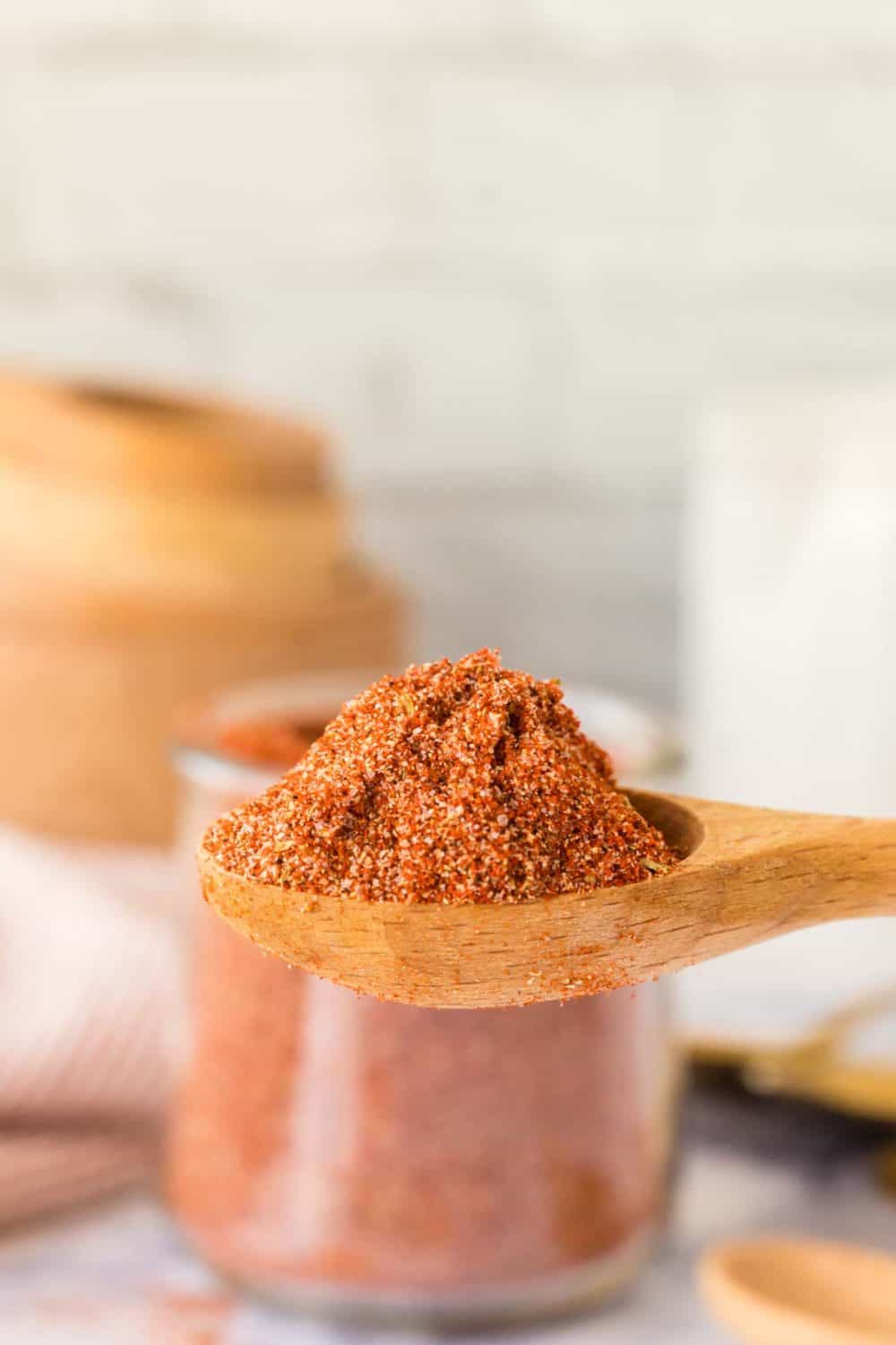 side view of a wooden spoon with homemade cajun seasoning