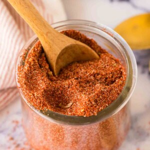 a small dish with cajun seasoning with a wooden spoon