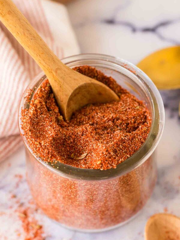 a small dish with cajun seasoning with a wooden spoon