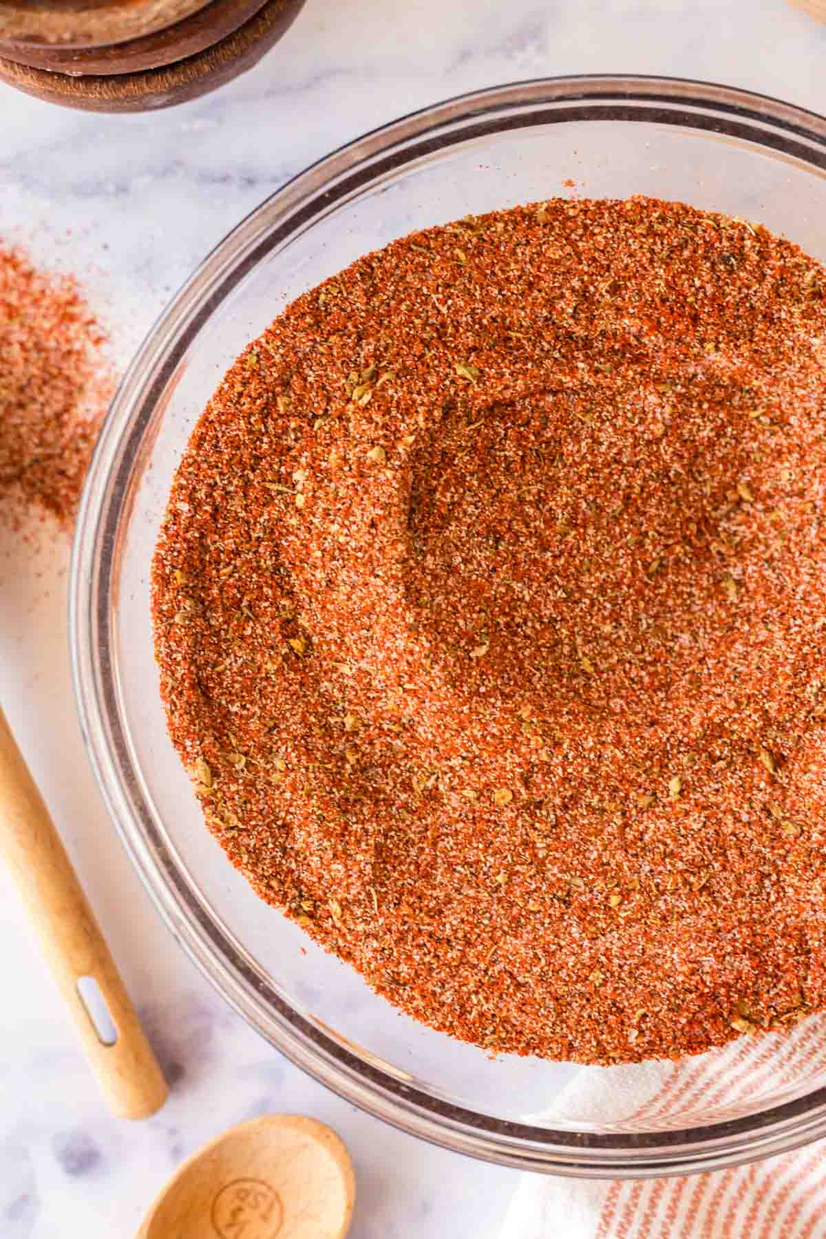 close up top view of a clear mixing bowl with cajun seasoning