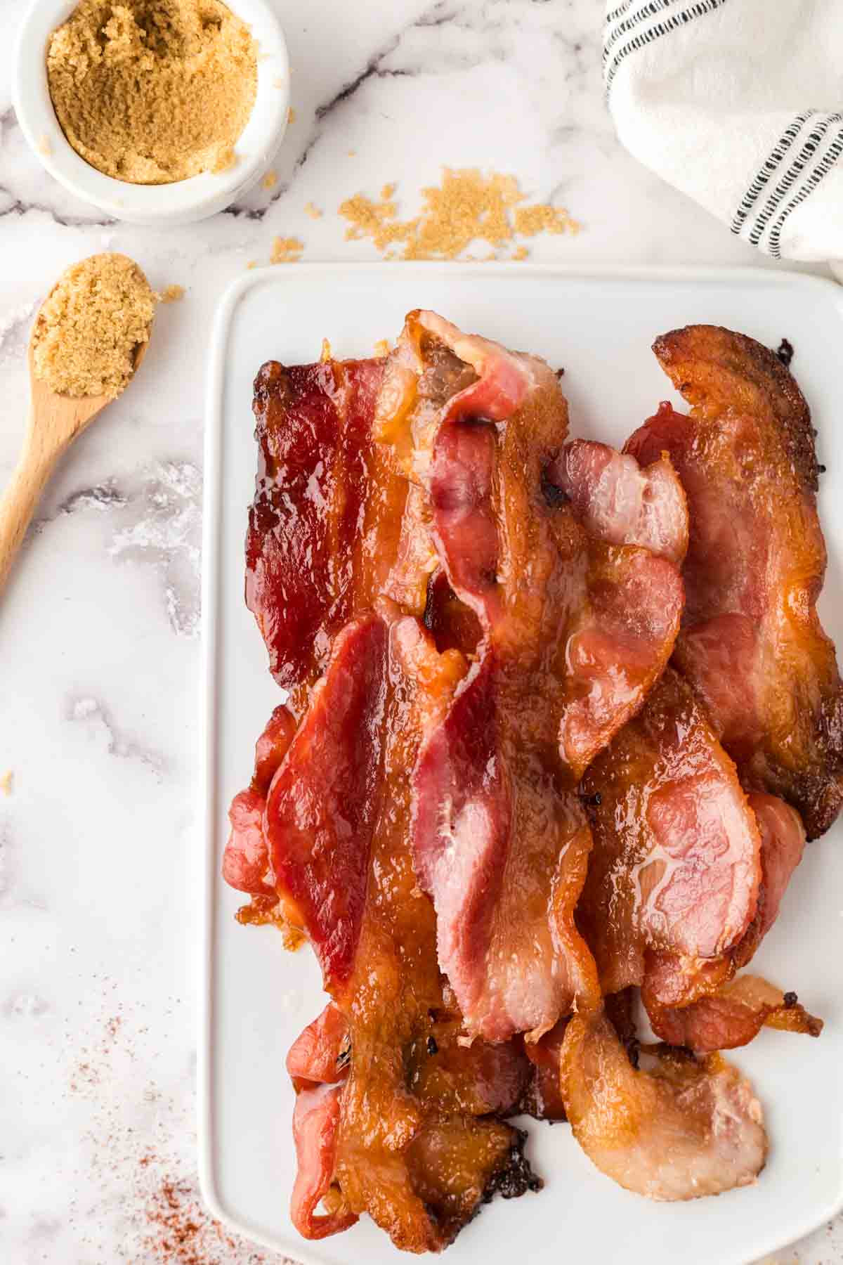 stack of candied bacon on a white tray