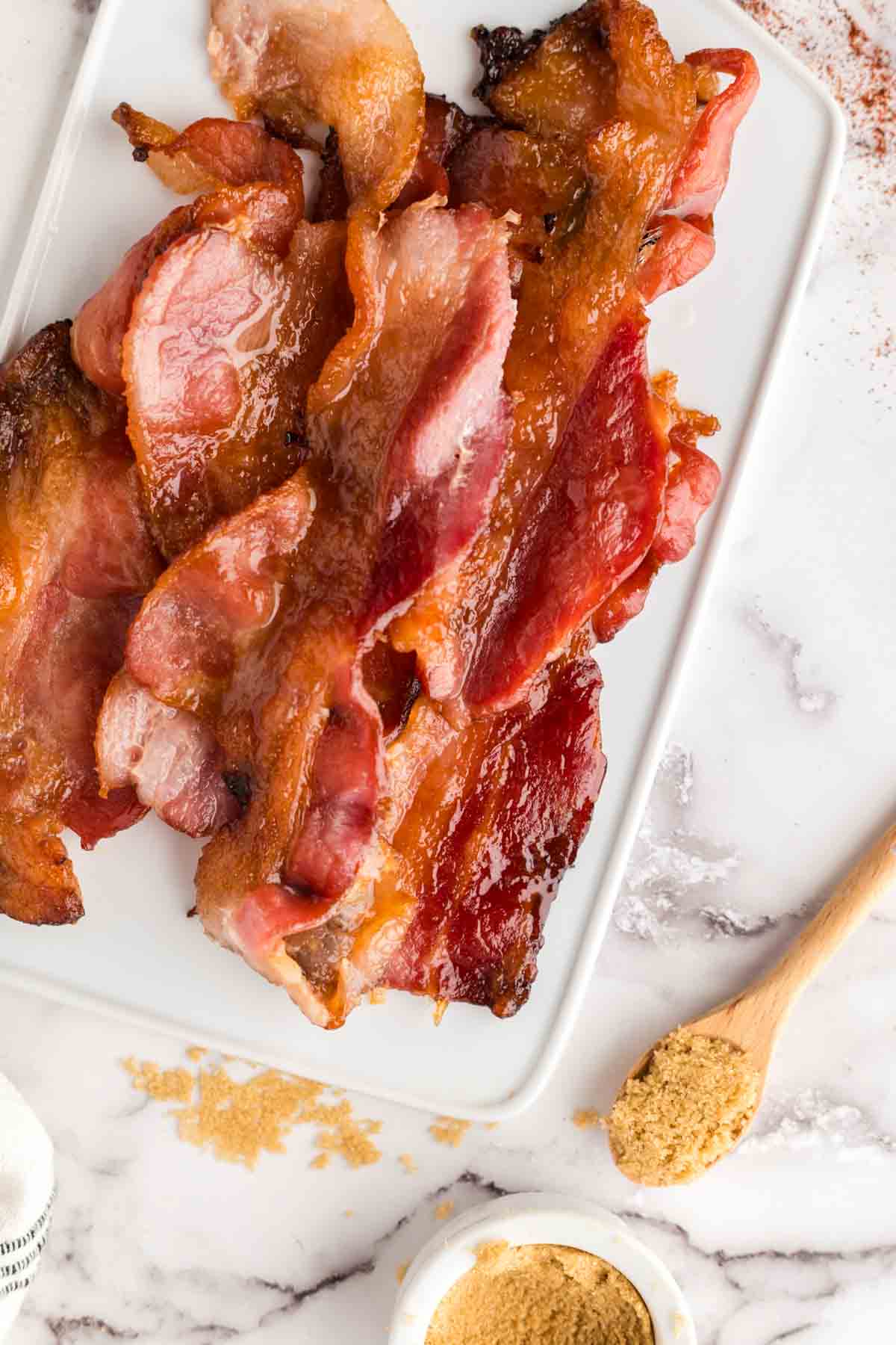 stack of candied bacon on a white tray
