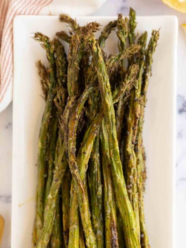 air fryer asparagus on a long rectangle plate.
