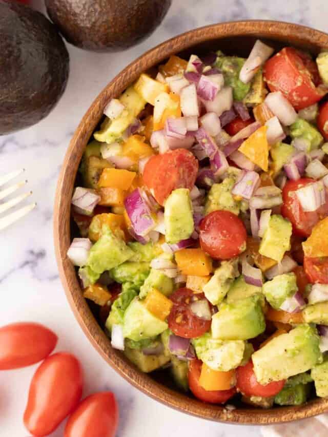 a wooden bowl of chopped avocado salad.