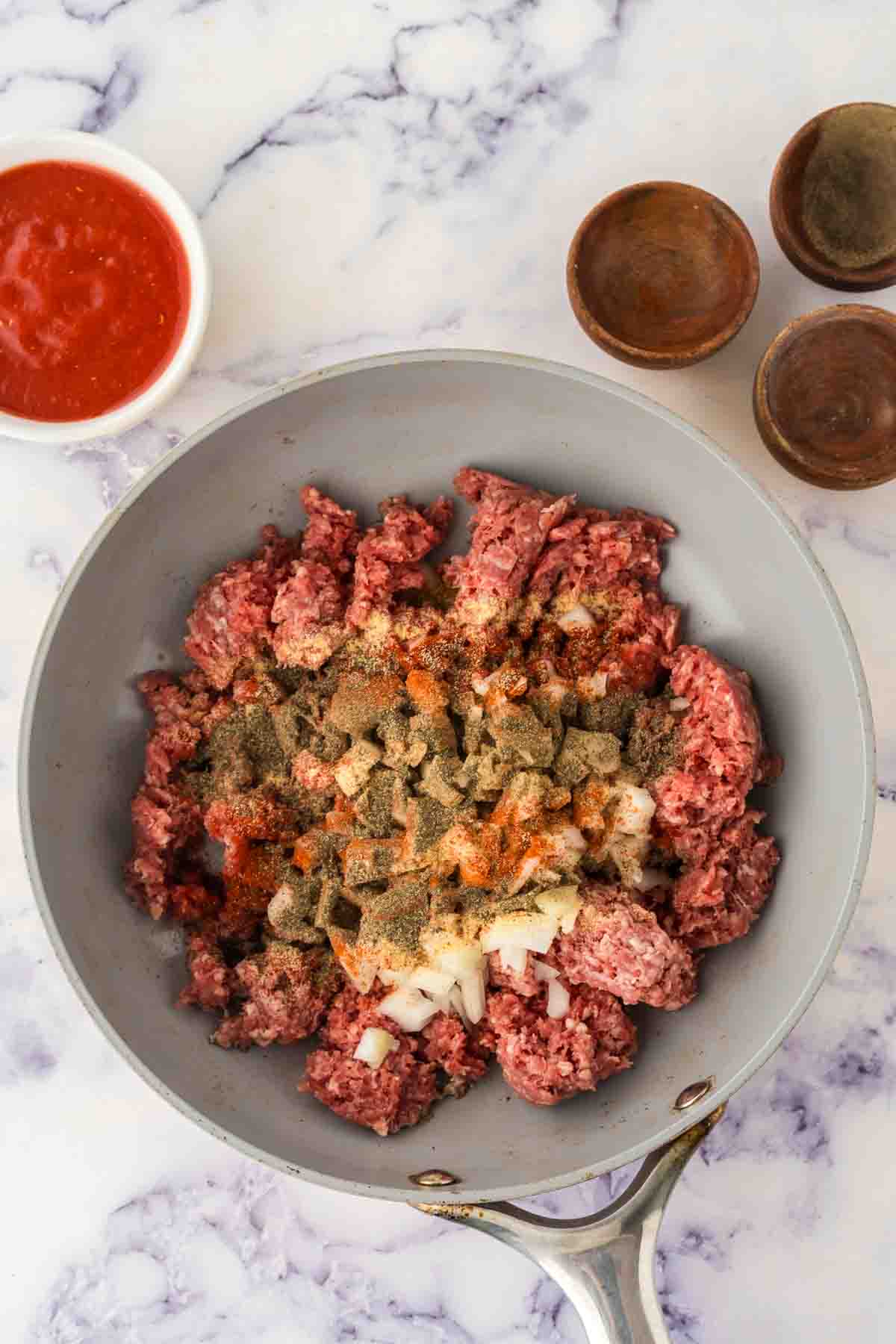 pan cooking hamburger and other raw ingredients for hot dog chili recipe