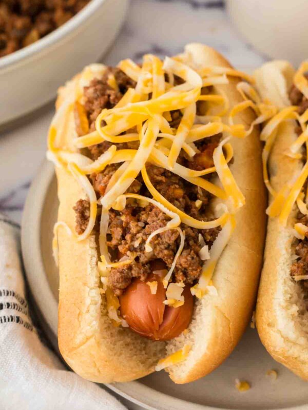 end view of two chili dogs on a plate.