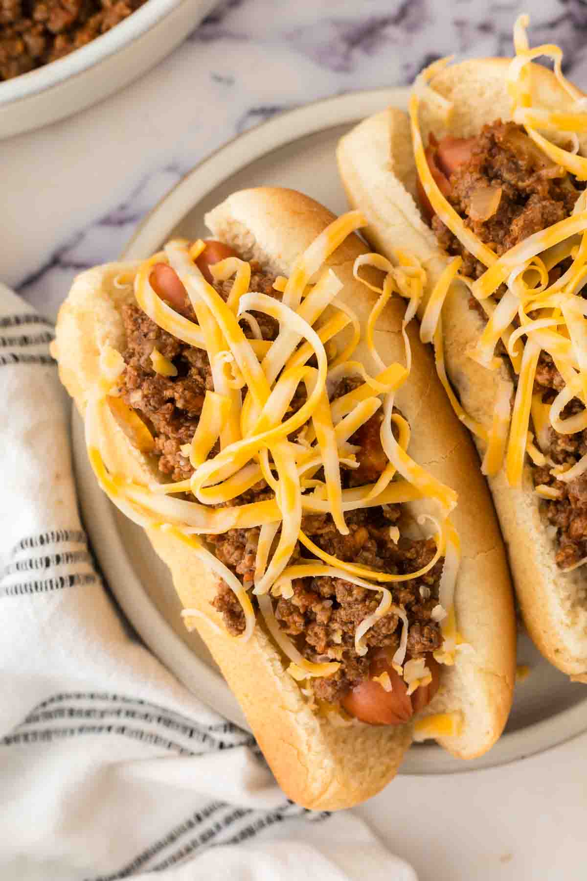 top view of two chili dogs on a plate