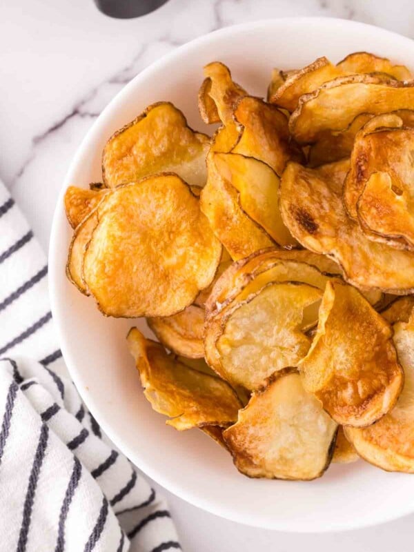 air fried potato chips in a white bowl.