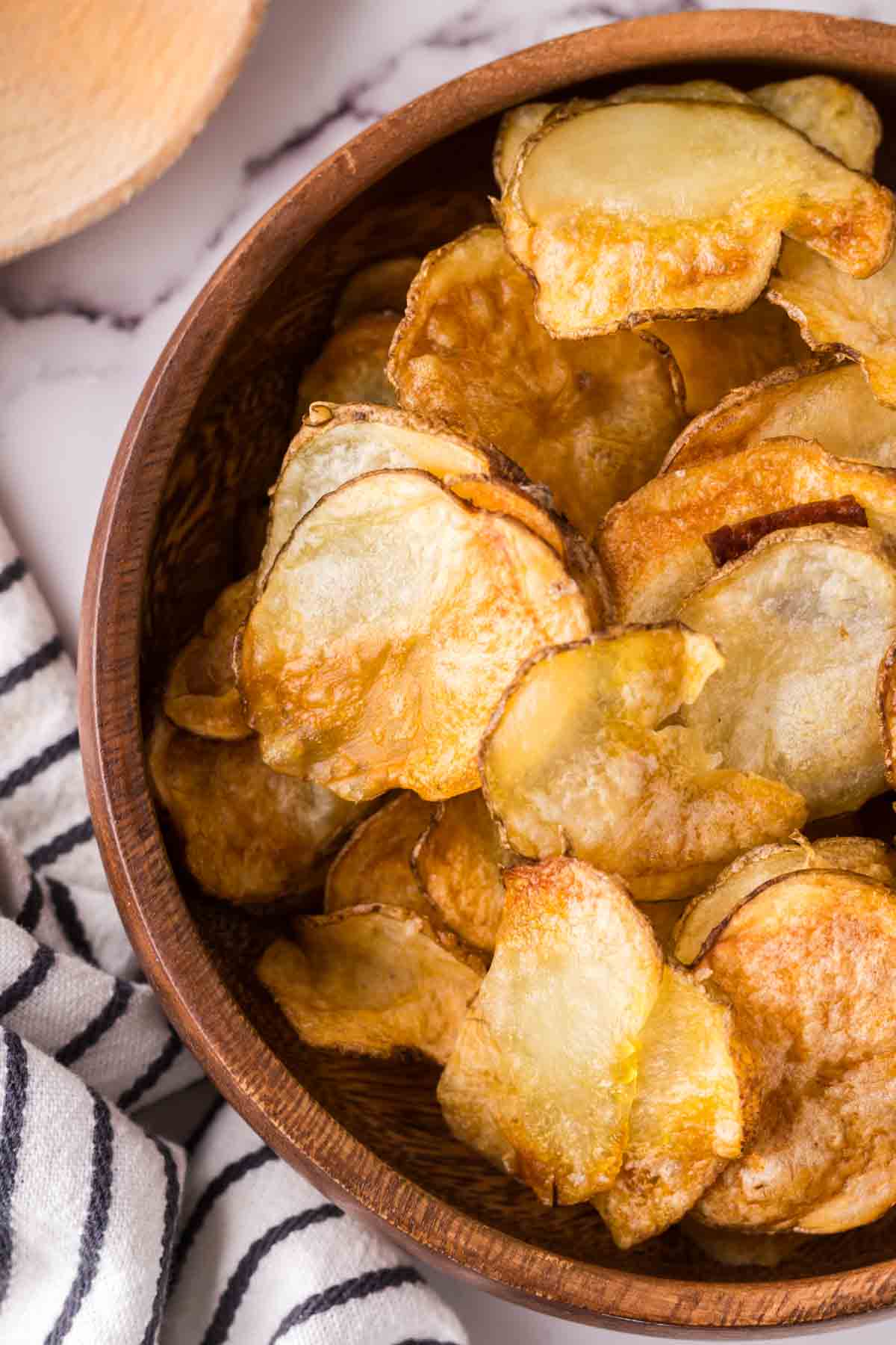 air fried potato chips in a wooden bowl.