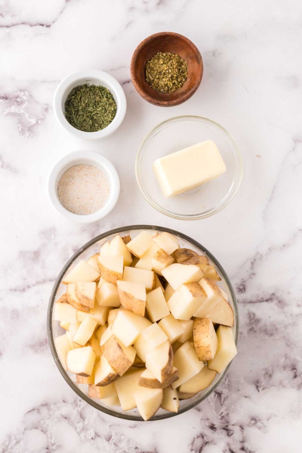 portion bowls each with raw ingredient to make air fryer roasted potatoes.