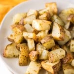 air fryer roasted potatoes with herbs on a plate.