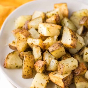 air fryer roasted potatoes with herbs on a plate.