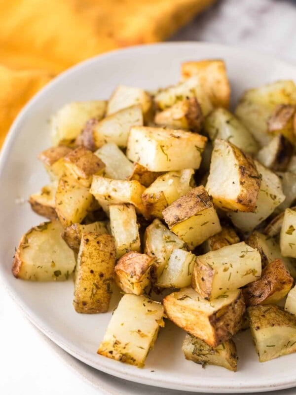 air fryer roasted potatoes with herbs on a plate.