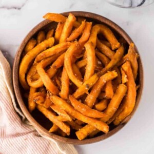 round wooden bowl with air fried sweet potato french fries.