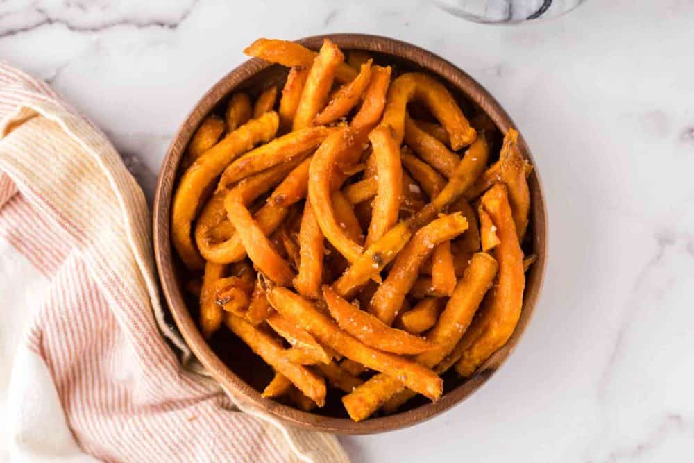 round wooden bowl with air fried sweet potato french fries.